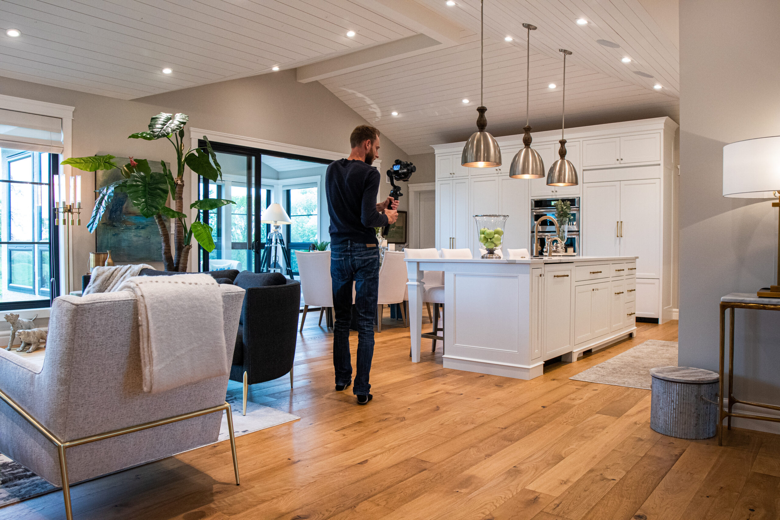 Photographer filming a house for real estate video.